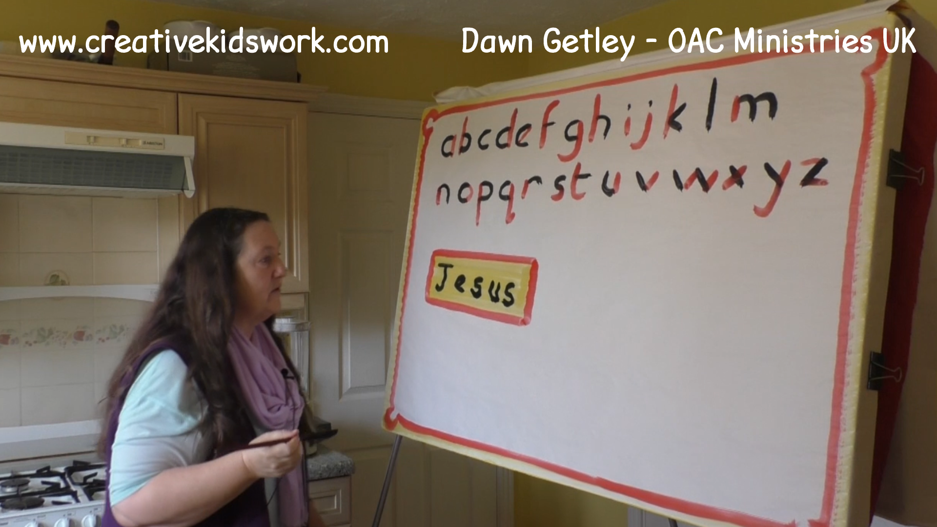 Dawn Getley demonstrates how to paint partial lettering on a sketchboard painting